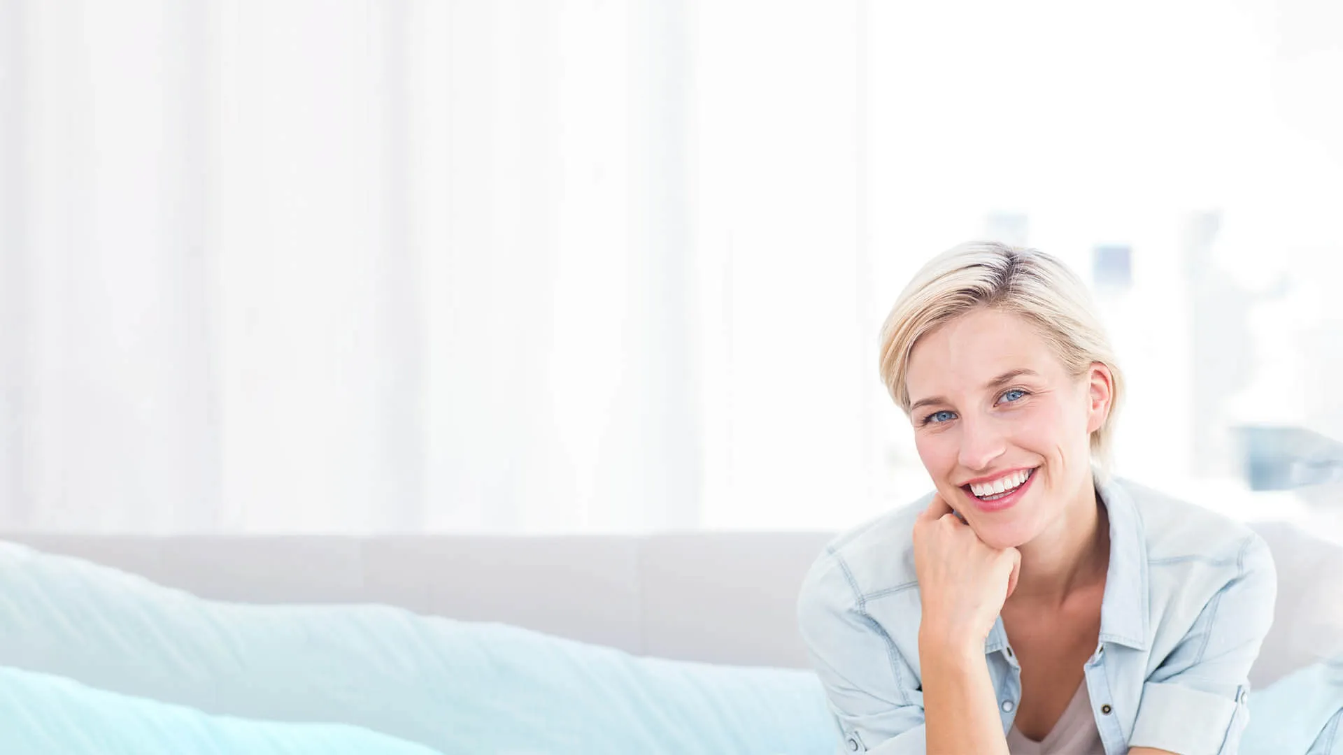 a woman smiling with her hand on her chin