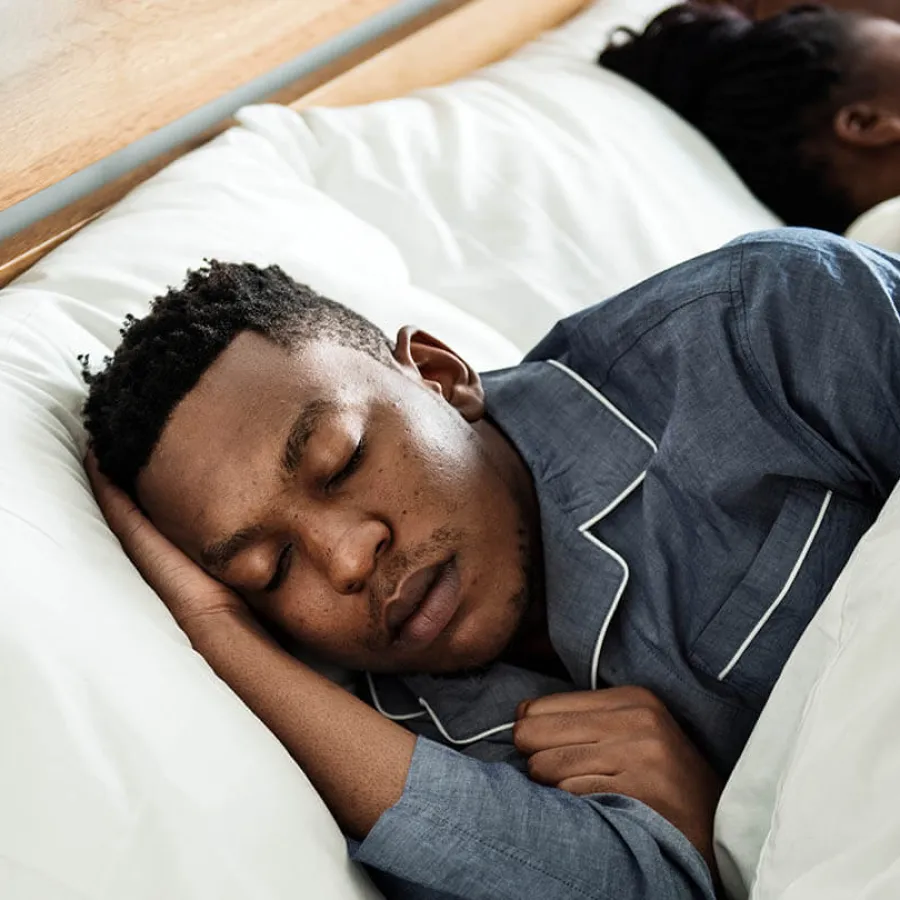 a man sleeping on a bed