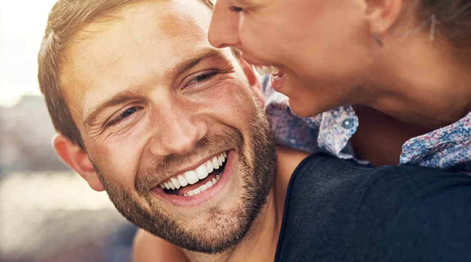 a man and a woman smiling